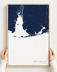 Alabama Gulf Coast canvas map — hands holding the canvas in an oak frame