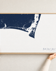 Bald Head Island canvas map — hands holding the canvas in an oak frame