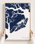 Beaufort / Sea Islands canvas map — hands holding the canvas in an oak frame