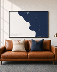 Central California Coast canvas map — two-pillow black-frame sofa interior
