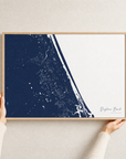 Daytona Beach canvas map — hands holding the canvas in an oak frame