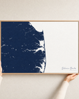 Delaware Beaches canvas map — hands holding the canvas in an oak frame