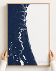 First Coast / Northeast Florida canvas map — hands holding the canvas in an oak frame
