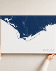 Forgotten Coast canvas map — hands holding the canvas in an oak frame