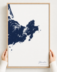 Gloucester canvas map — hands holding the canvas in an oak frame
