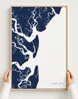 Jekyll Island canvas map — hands holding the canvas in an oak frame
