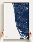 Naples canvas map — hands holding the canvas in an oak frame