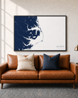 Outer Banks canvas map — two-pillow black-frame sofa interior
