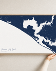 Panama City Beach canvas map — hands holding the canvas in an oak frame