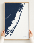 Assateague vertical canvas map in Navy, hands holding an oak-framed canvas