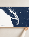 Salish Sea horizontal canvas map in Navy, hands holding an oak-framed canvas