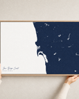 San Diego Coast canvas map — hands holding the canvas in an oak frame