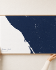 Sonoma Coast canvas map — hands holding the canvas in an oak frame