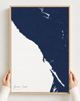 Sonoma Coast canvas map — hands holding the canvas in an oak frame