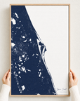 Space Coast canvas map — hands holding the canvas in an oak frame