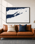 The Hamptons canvas map — two-pillow black-frame sofa interior