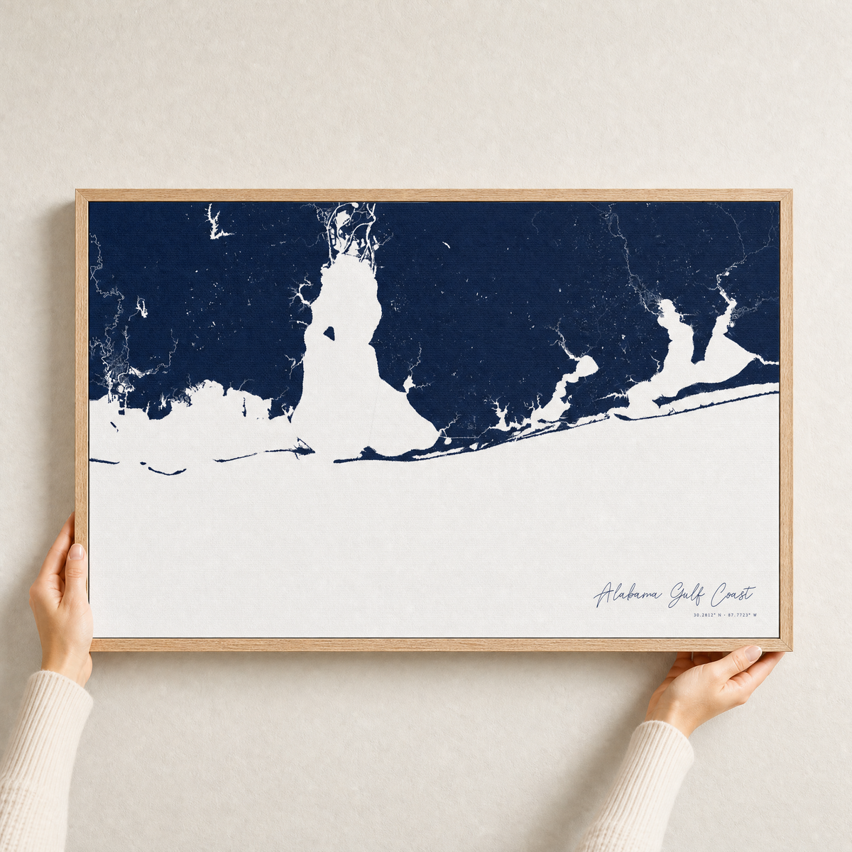 Alabama Gulf Coast canvas map — hands holding the canvas in an oak frame
