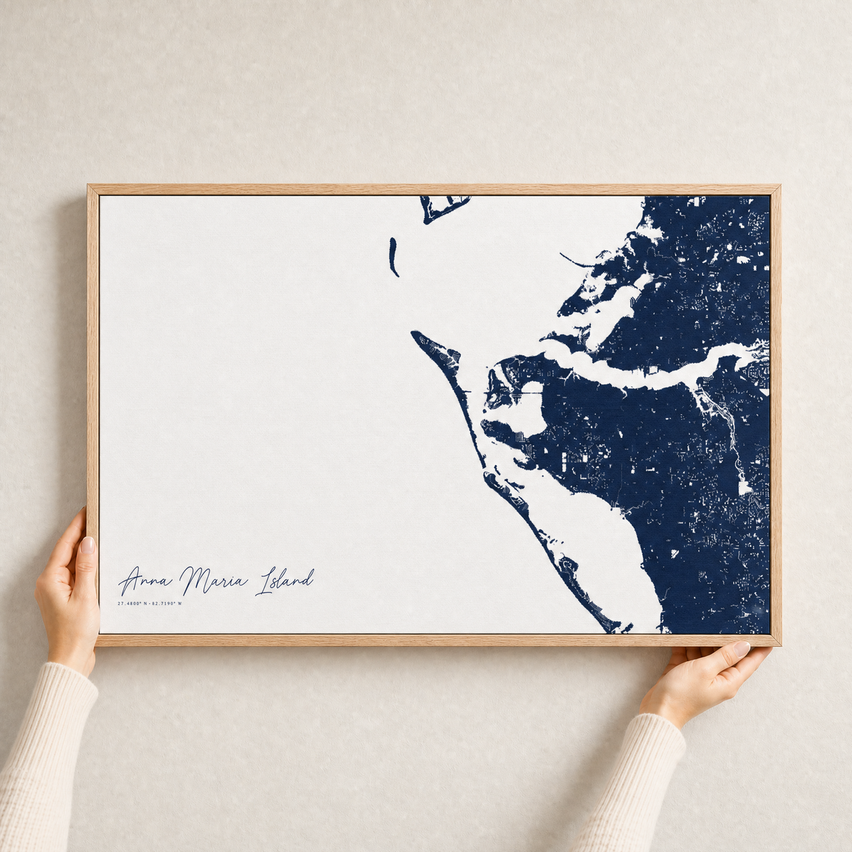 Anna Maria Island canvas map — hands holding the canvas in an oak frame