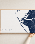 Anna Maria Island canvas map — hands holding the canvas in an oak frame