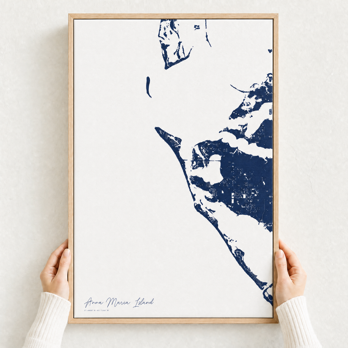 Anna Maria Island canvas map — hands holding the canvas in an oak frame