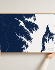 Annapolis canvas map — hands holding the canvas in an oak frame