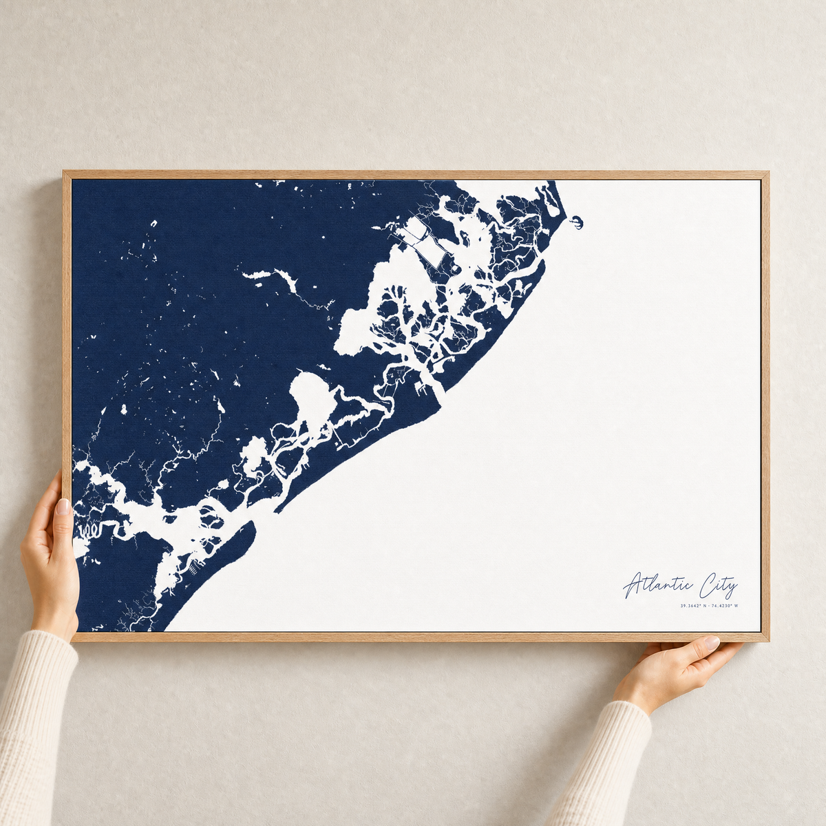 Atlantic City canvas map — hands holding the canvas in an oak frame