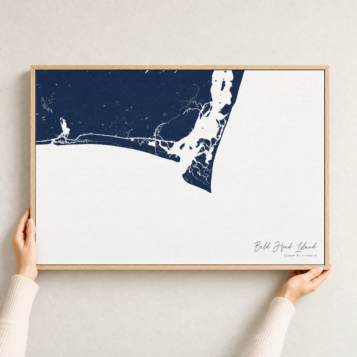 Bald Head Island canvas map — hands holding the canvas in an oak frame