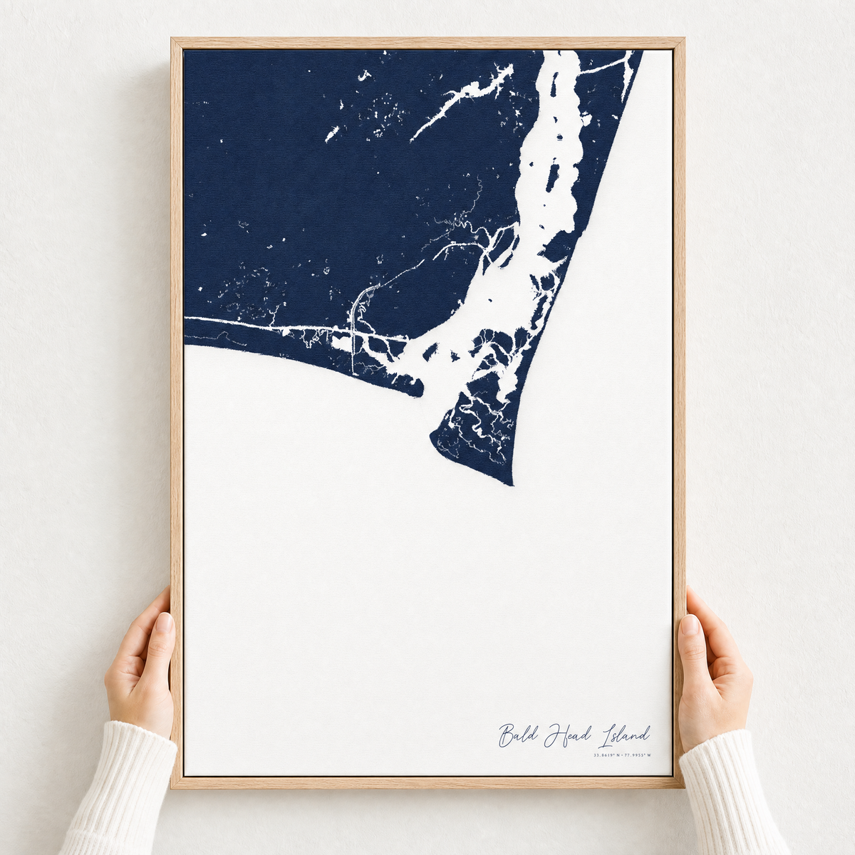 Bald Head Island canvas map — hands holding the canvas in an oak frame