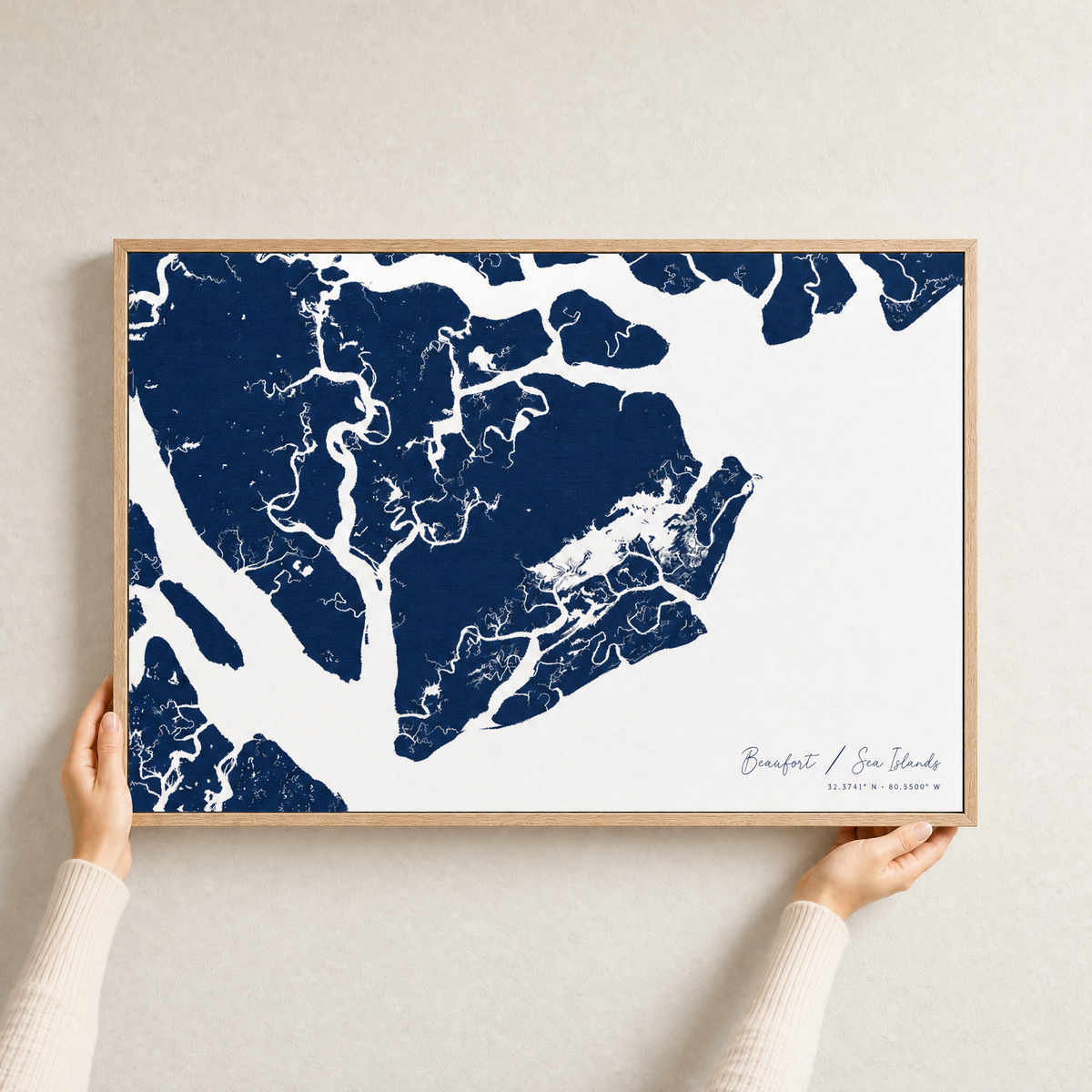 Beaufort / Sea Islands canvas map — hands holding the canvas in an oak frame