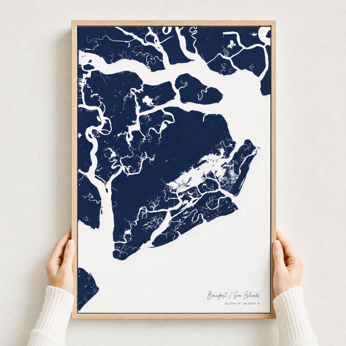 Beaufort / Sea Islands canvas map — hands holding the canvas in an oak frame