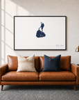 Block Island canvas map — two-pillow black-frame sofa interior