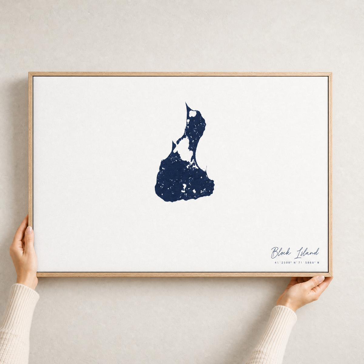 Block Island canvas map — hands holding the canvas in an oak frame