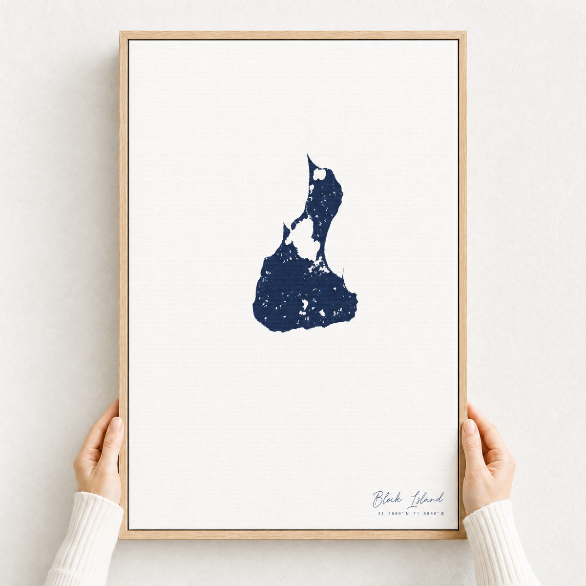Block Island canvas map — hands holding the canvas in an oak frame