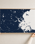 Boston canvas map — hands holding the canvas in an oak frame