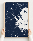 Boston canvas map — hands holding the canvas in an oak frame
