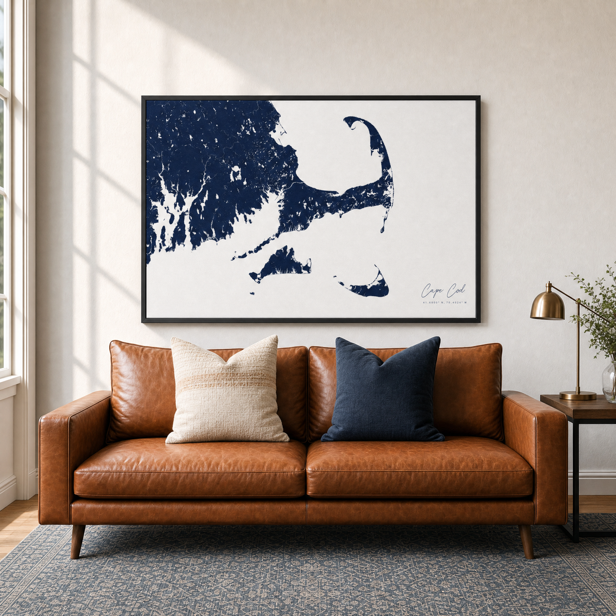 Cape Cod canvas map — two-pillow black-frame sofa interior