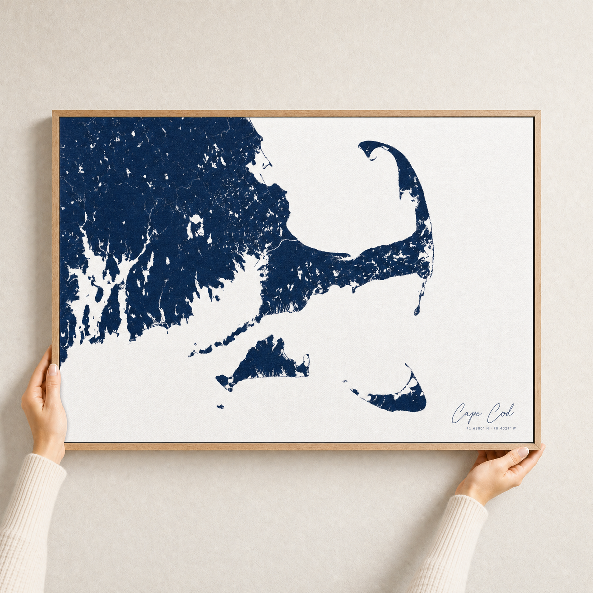 Cape Cod canvas map — hands holding the canvas in an oak frame
