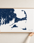 Cape Cod canvas map — hands holding the canvas in an oak frame