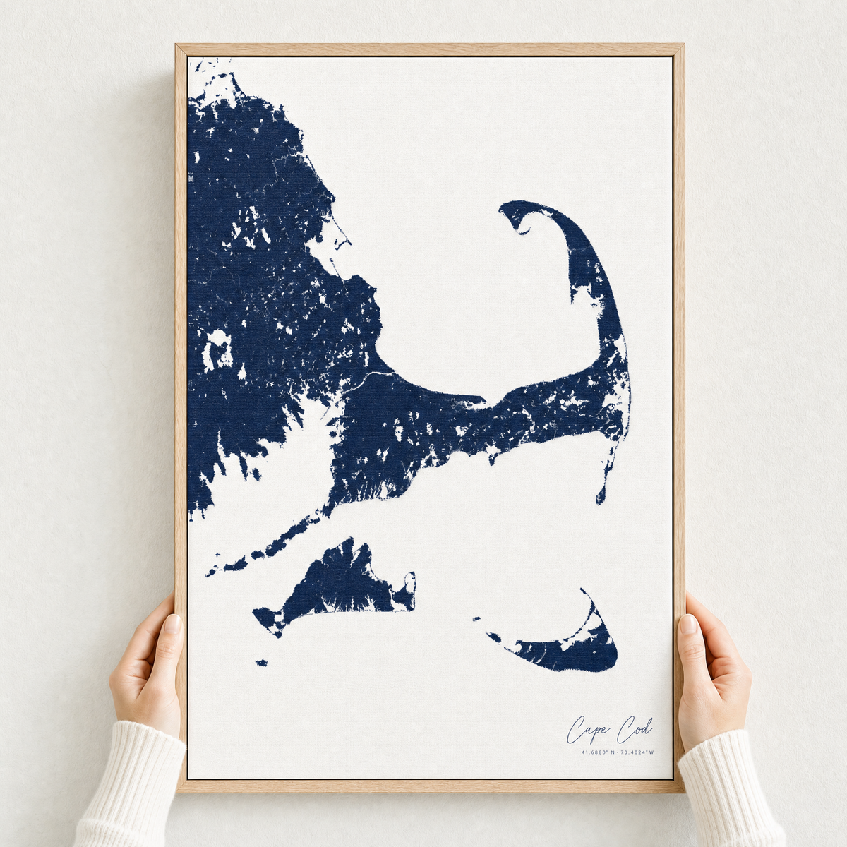 Cape Cod canvas map — hands holding the canvas in an oak frame