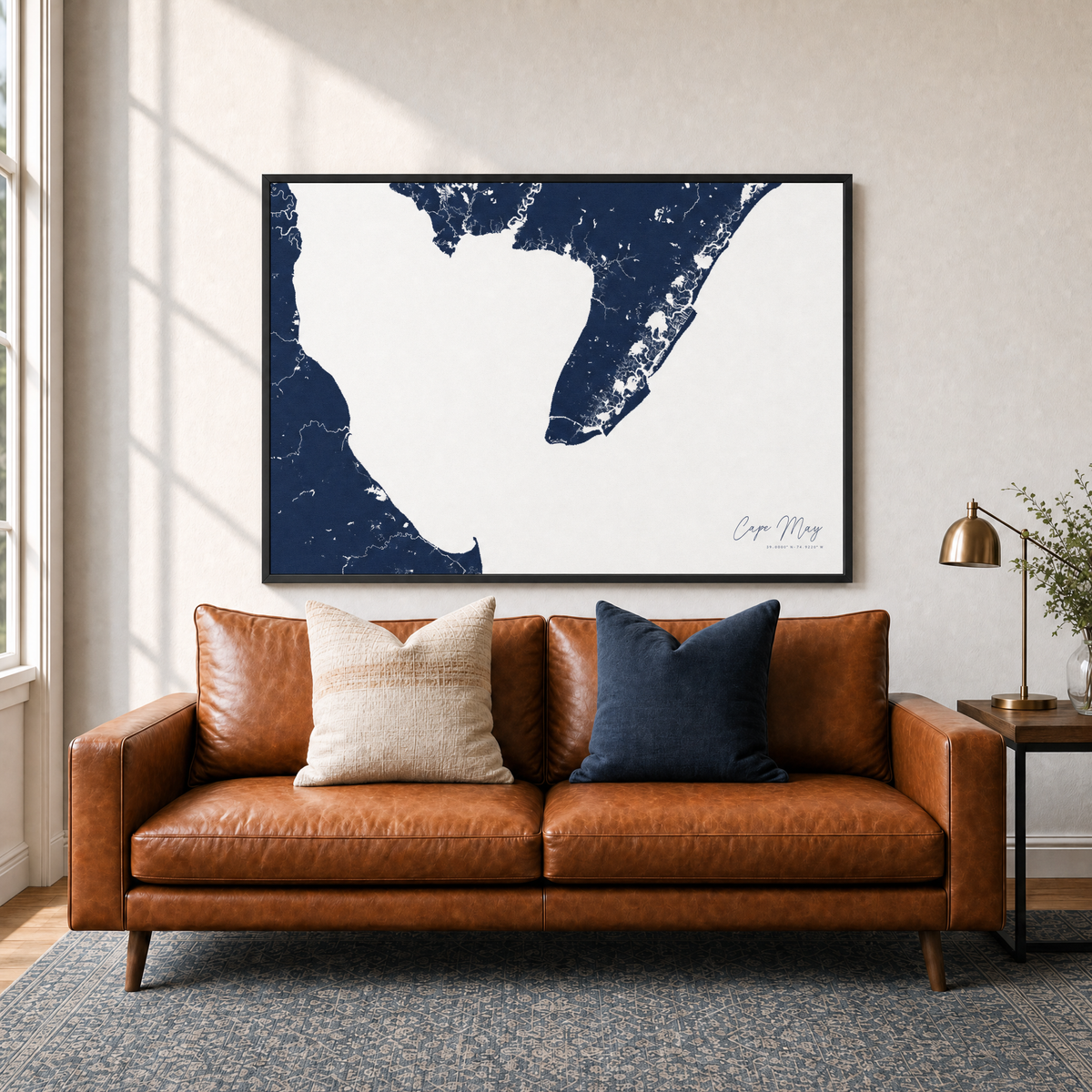 Cape May canvas map — two-pillow black-frame sofa interior