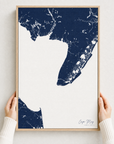Cape May canvas map — hands holding the canvas in an oak frame