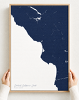 Central California Coast canvas map — hands holding the canvas in an oak frame