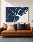 Charleston canvas map — two-pillow black-frame sofa interior
