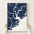 Charleston canvas map — hands holding the canvas in an oak frame