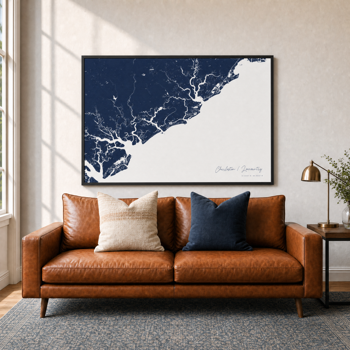 Charleston / Lowcountry canvas map — two-pillow black-frame sofa interior