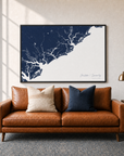 Charleston / Lowcountry canvas map — two-pillow black-frame sofa interior