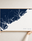 Charleston / Lowcountry canvas map — hands holding the canvas in an oak frame