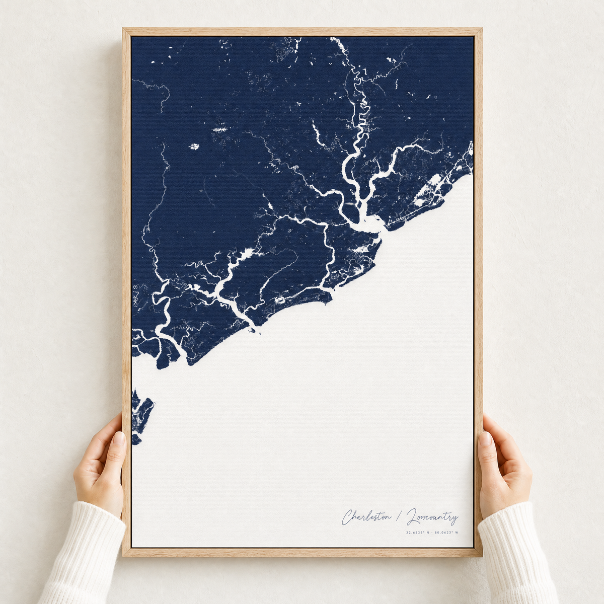 Charleston / Lowcountry canvas map — hands holding the canvas in an oak frame
