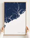 Charleston / Lowcountry canvas map — hands holding the canvas in an oak frame