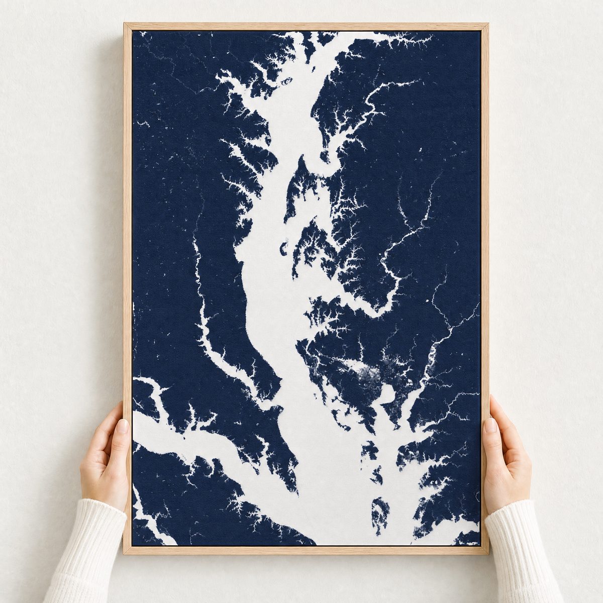 Chesapeake Bay / Maryland canvas map — hands holding the canvas in an oak frame